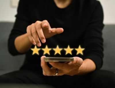 person holding phone with 5 stars hovering